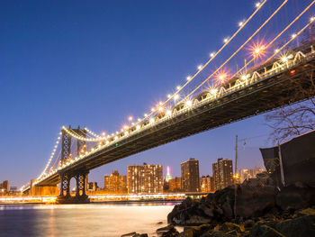 Low angle view of suspension bridge at night