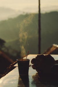 Cropped hand of woman using mobile phone