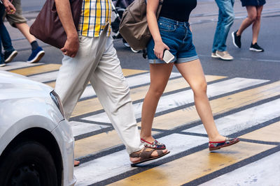 Low section of people walking on road