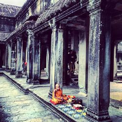 Woman standing by wall
