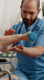 Doctor assisting woman in exercise