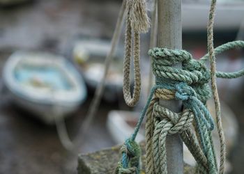 Ropes tied on pole at harbor