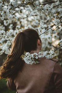 Portrait of woman with cherry blossoms outdoors