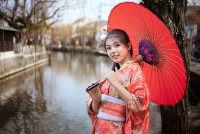 Beautiful female wearing traditional japanese kimono in yanagawa river fukuoka, japan.