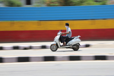 Full length of man riding motorcycle