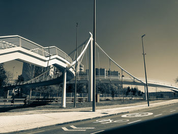 Bridge over road against sky in city