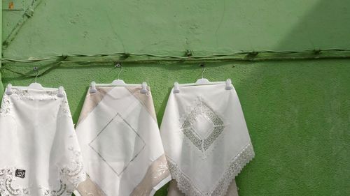 Close-up of clothes drying against wall