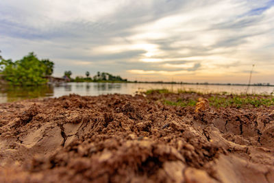 Surface level of land against sky during sunset