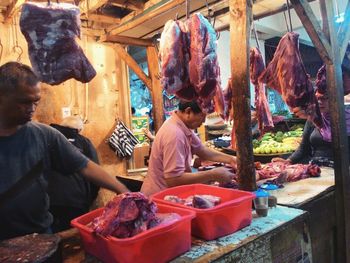 Man and vegetables for sale in market