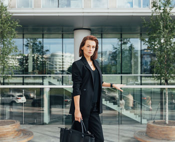 Portrait of businessman standing in city