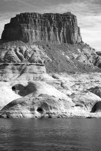 Rock formations on sea shore against sky