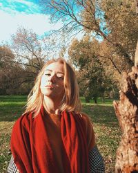 Portrait of woman standing against plants