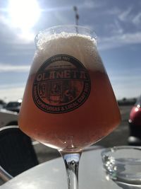 Close-up of wine glass against sky