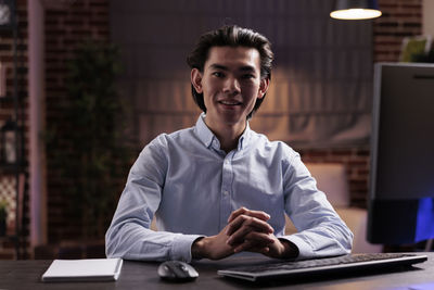 Young man using laptop at table