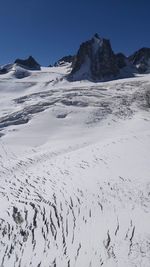 Scenic view of snowcapped mountains against clear sky