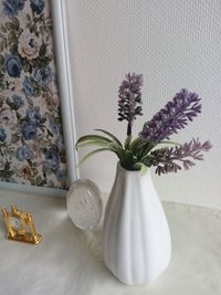 Close-up of white flower vase on table at home