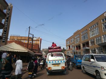 Vehicles on road along buildings