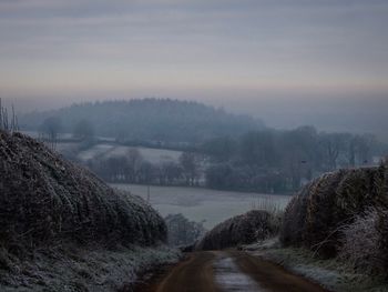 Scenic view of landscape against sky during winter