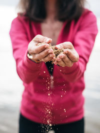 Close-up of woman holding sand