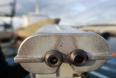 Close-up of coin-operated binoculars against blurred background