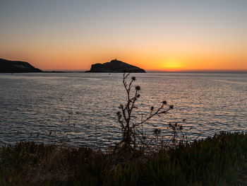 Scenic view of sea against orange sky