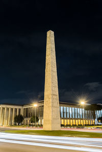 Low angle view of illuminated obelisk against sky at night