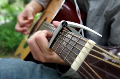 Close-up of man playing guitar