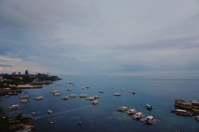 High angle view of boats in sea against sky