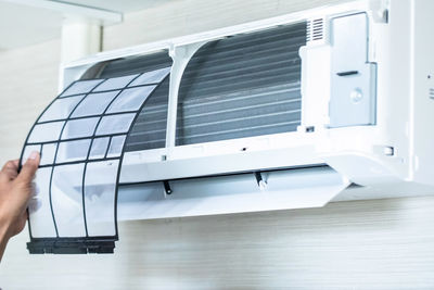 Cropped hand of man using laptop