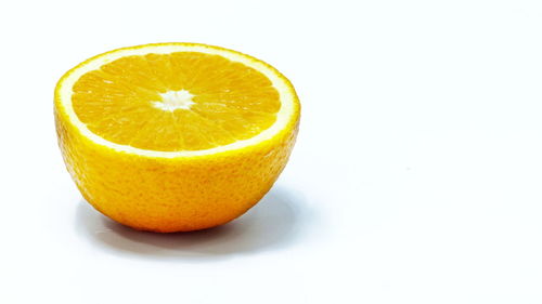 Close-up of orange slice against white background