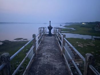 Pier over sea against clear sky