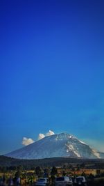 View of snowcapped mountain against blue sky