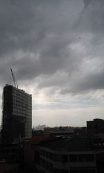 Buildings against cloudy sky