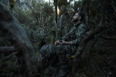 Hunter resting in forest