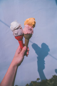 Human hand holding ice cream cone