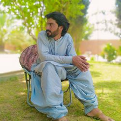 Young man sitting on grass