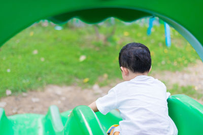 Rear view of boy on field