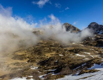 Aerial view of mountain range against blue sky