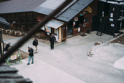 People walking on street amidst buildings in city