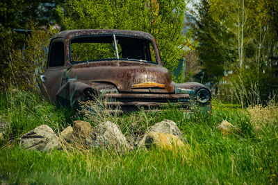 Abandoned car on field