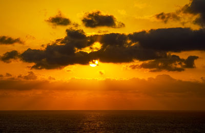 Scenic view of sea against orange sky