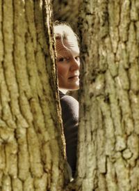 Portrait of woman through trees