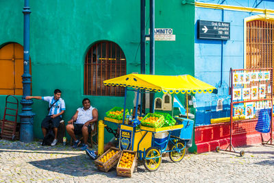 People sitting on chair outside building