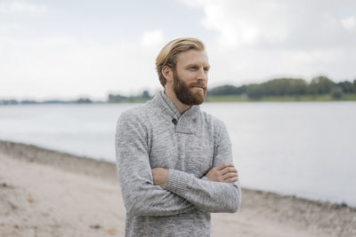 Germany, duesseldorf, portrait of man on the beach