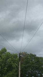 Low angle view of telephone pole against sky