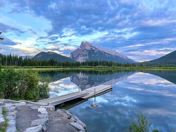 Scenic view of lake by mountains against sky