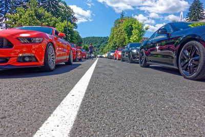 Cars on road against sky in city