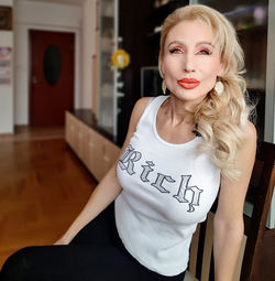 Beautiful woman sitting on chair at home