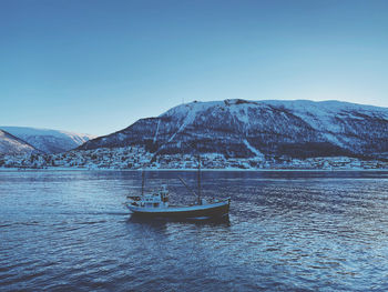 Scenic view of snowcapped mountains against clear blue sky