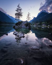 Scenic view of lake and mountains against sky